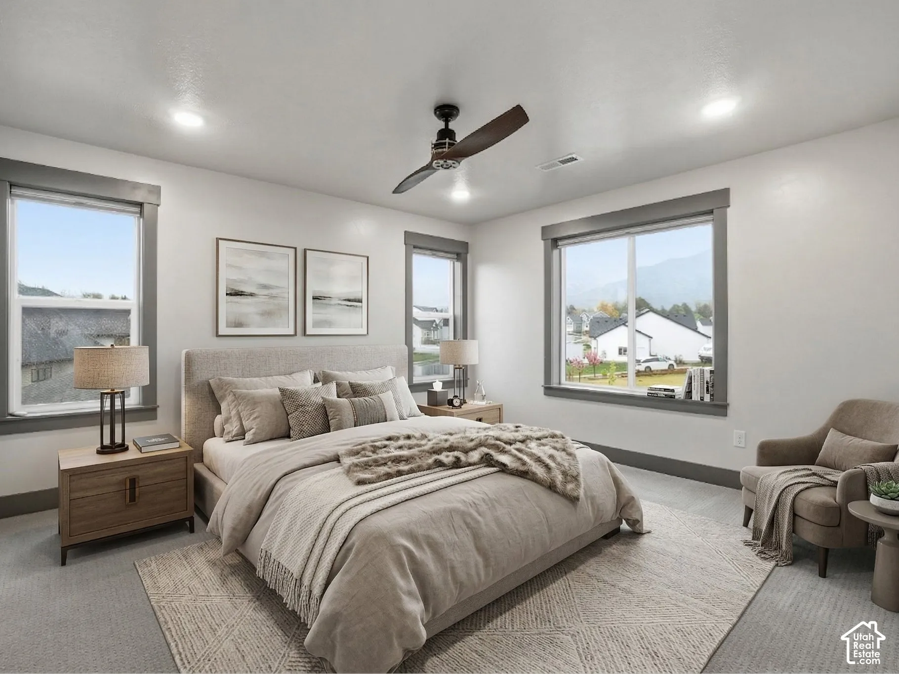 Neutral-toned interior space featuring three large windows with dark-finish frames, recessed ceiling lighting, wall-to-wall carpeting, and a dark-finish ceiling fan