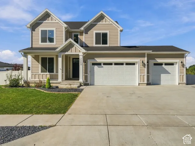 Two-story residence featuring horizontal siding, a gabled roofline, a covered entryway, a three-car garage, and concrete driveway