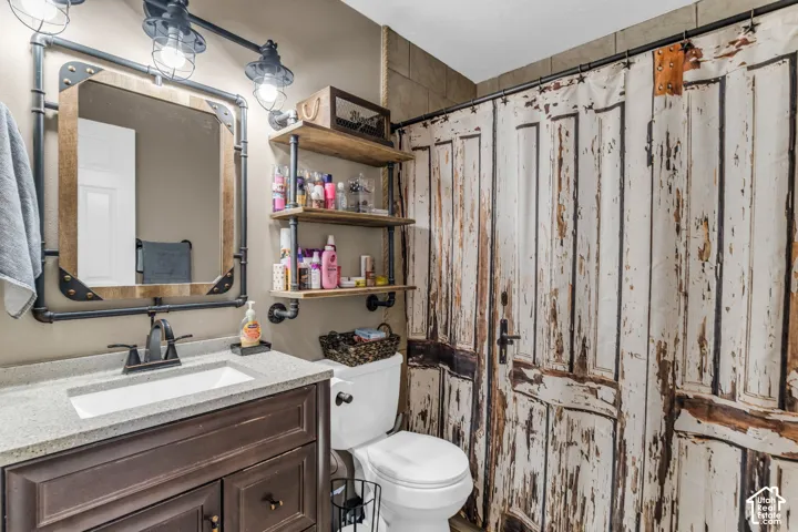 Vanity featuring a dark-toned cabinet base with a neutral solid-surface countertop and integrated rectangular sink
