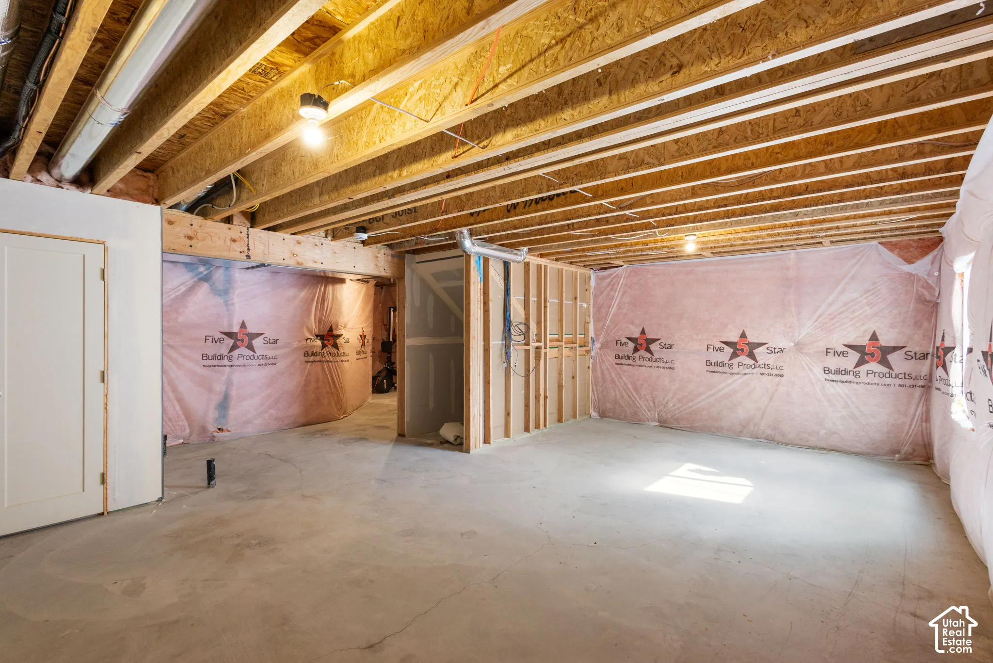 Unfinished space featuring exposed wood-joist ceilings, concrete flooring, and insulated foundation walls