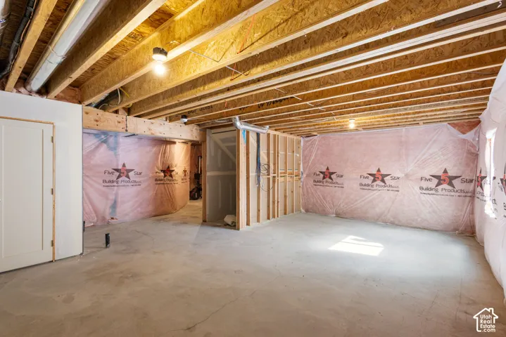 Unfinished space featuring exposed wood-joist ceilings, concrete flooring, and insulated foundation walls