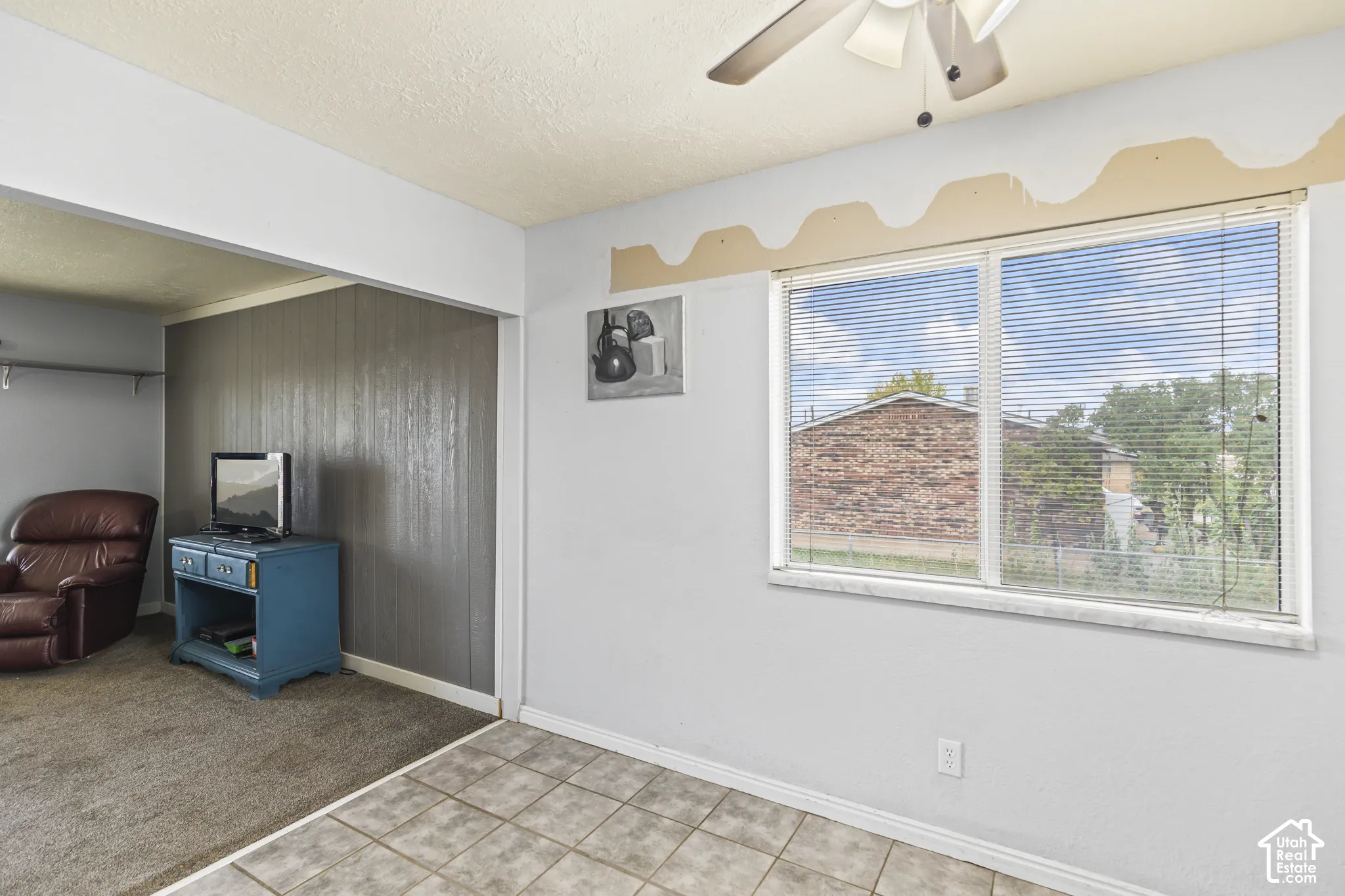 Interior space featuring ceramic tile flooring, horizontal window blinds, and a ceiling fan