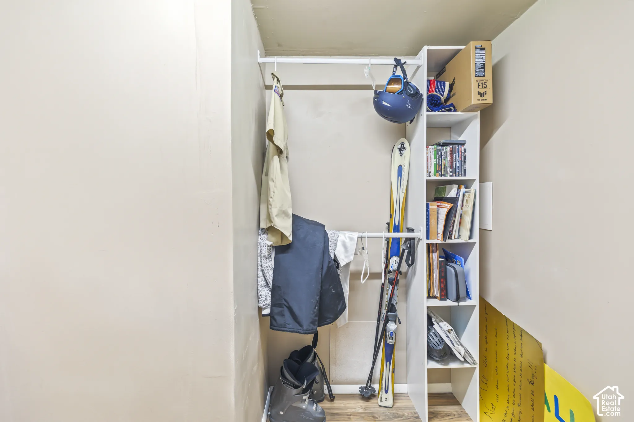Built-in white shelving unit with vertical cubbies and integrated closet rod