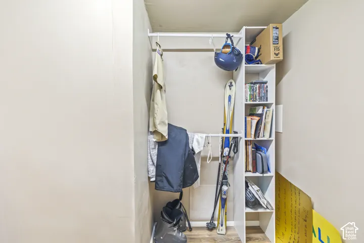 Built-in white shelving unit with vertical cubbies and integrated closet rod
