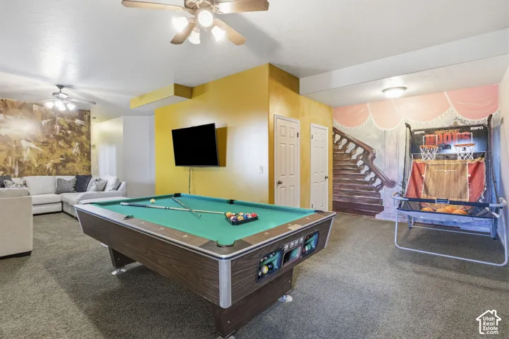 Spacious room featuring carpeting, dual ceiling fans, and two solid-core interior doors