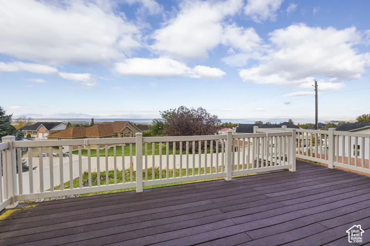 Elevated composite deck featuring white synthetic railing and expansive mountain and water scenery
