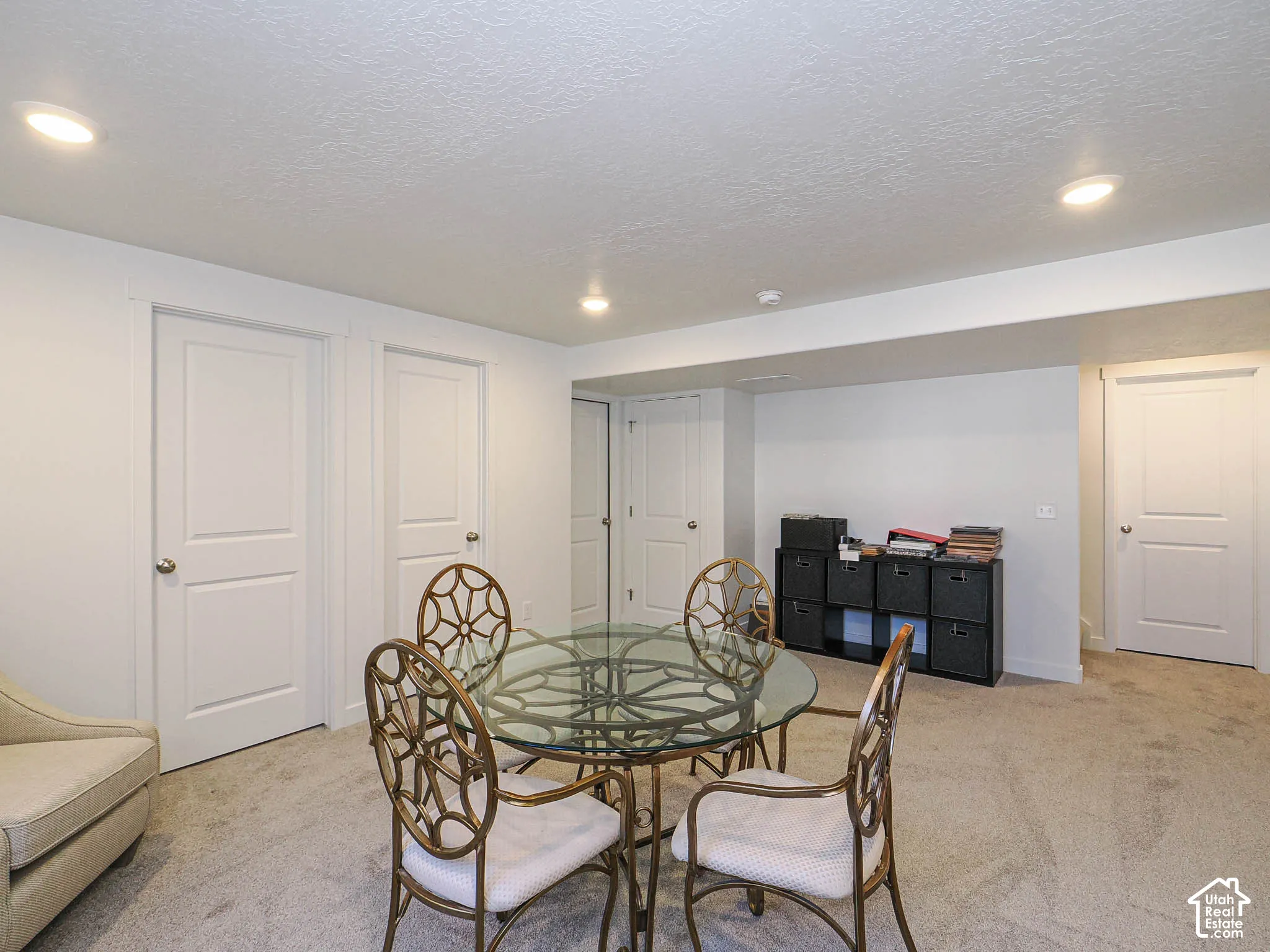 Neutral-toned room featuring recessed ceiling lighting, wall-to-wall carpeting, and four paneled interior doors