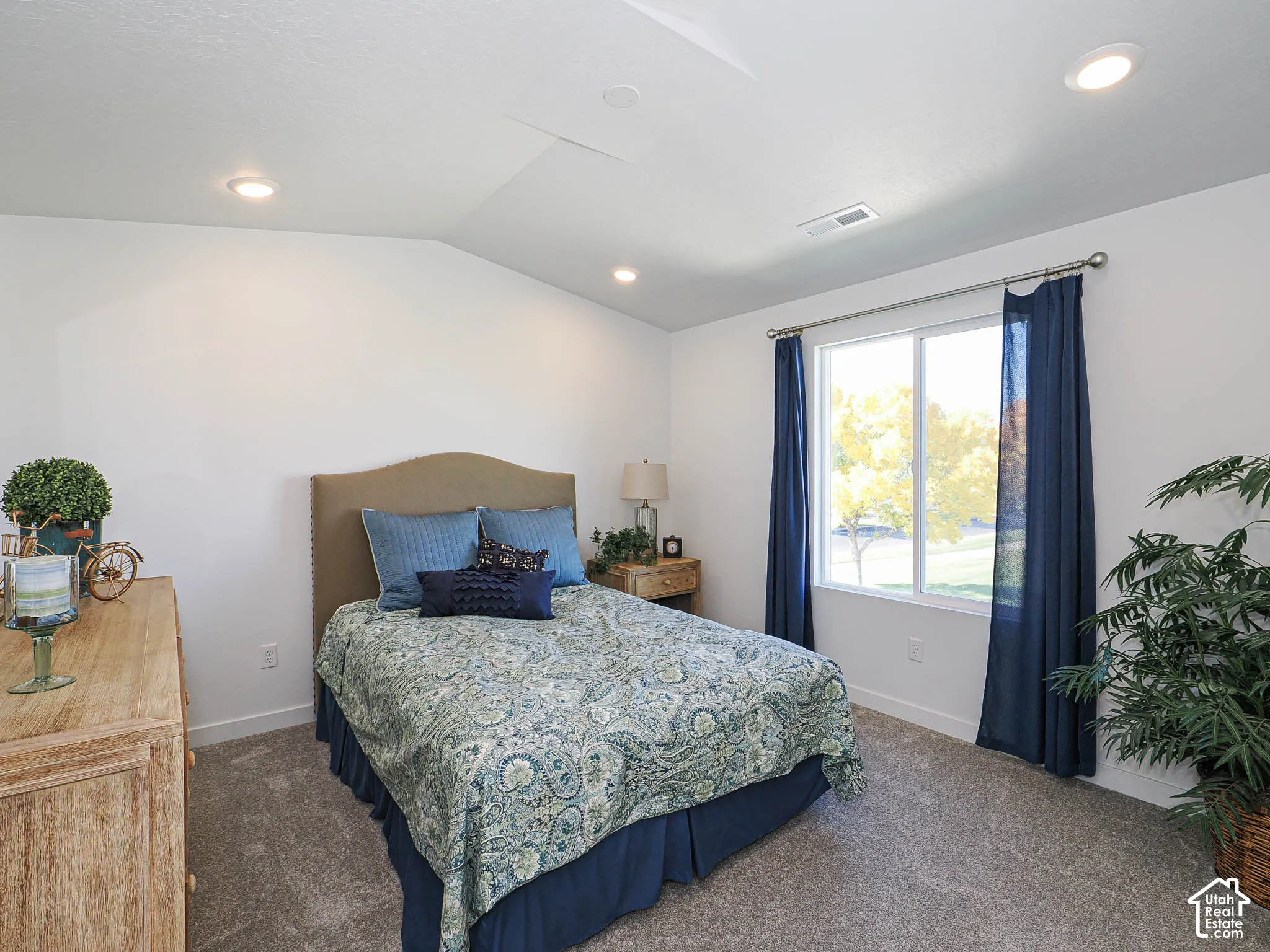 Vaulted ceilings, recessed lighting, and wall-to-wall carpeting featuring a large window with horizontal slider operation
