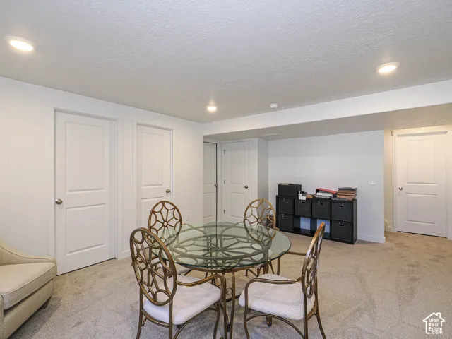 Neutral-toned room featuring recessed ceiling lighting, wall-to-wall carpeting, and four paneled interior doors