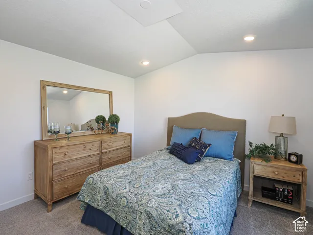 Vaulted ceiling featuring recessed lighting and neutral wall-to-wall carpeting