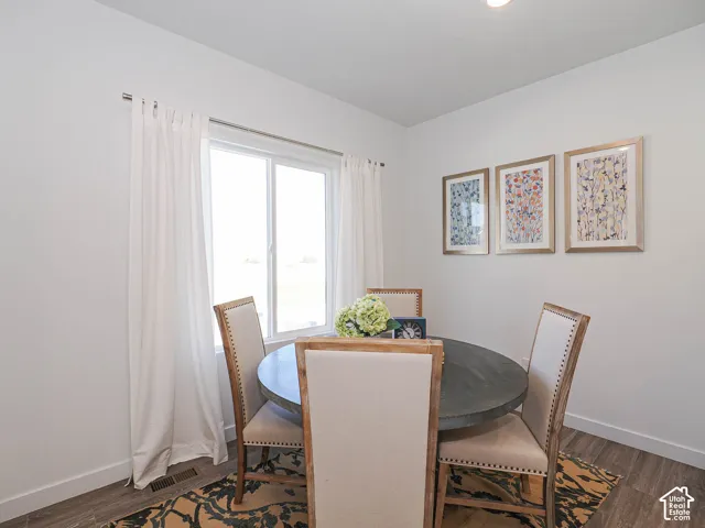 Neutral-toned interior space featuring wood-finish flooring and a dual-pane sliding window
