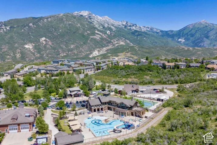 Suncrest features a community clubhouse, outdoor swimming pool with water slide, tennis courts, and mountainous backdrop