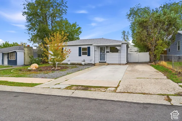 The driveway runs to a gated side yard and the detached two-car garage behind the house. There is room for about five vehicles.
