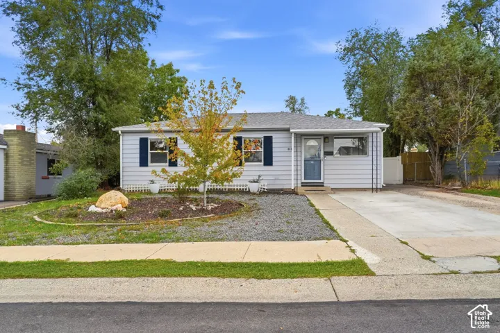A four-bedroom, one-level rambler with a roof replaced in July 2026, a two-car garage and a fenced backyard, all on a wide concrete driveway.