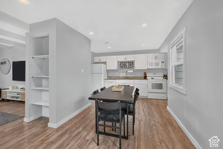Looking from the dining area toward the kitchen, with a built-in shelving niche separating it from the living room. The open layout keeps everything in sight.