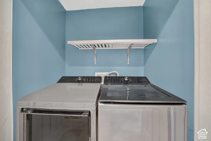 The laundry sits behind the double doors off the back entry, with a wall shelf and an electric dryer hookup. The washer and dryer are not included.