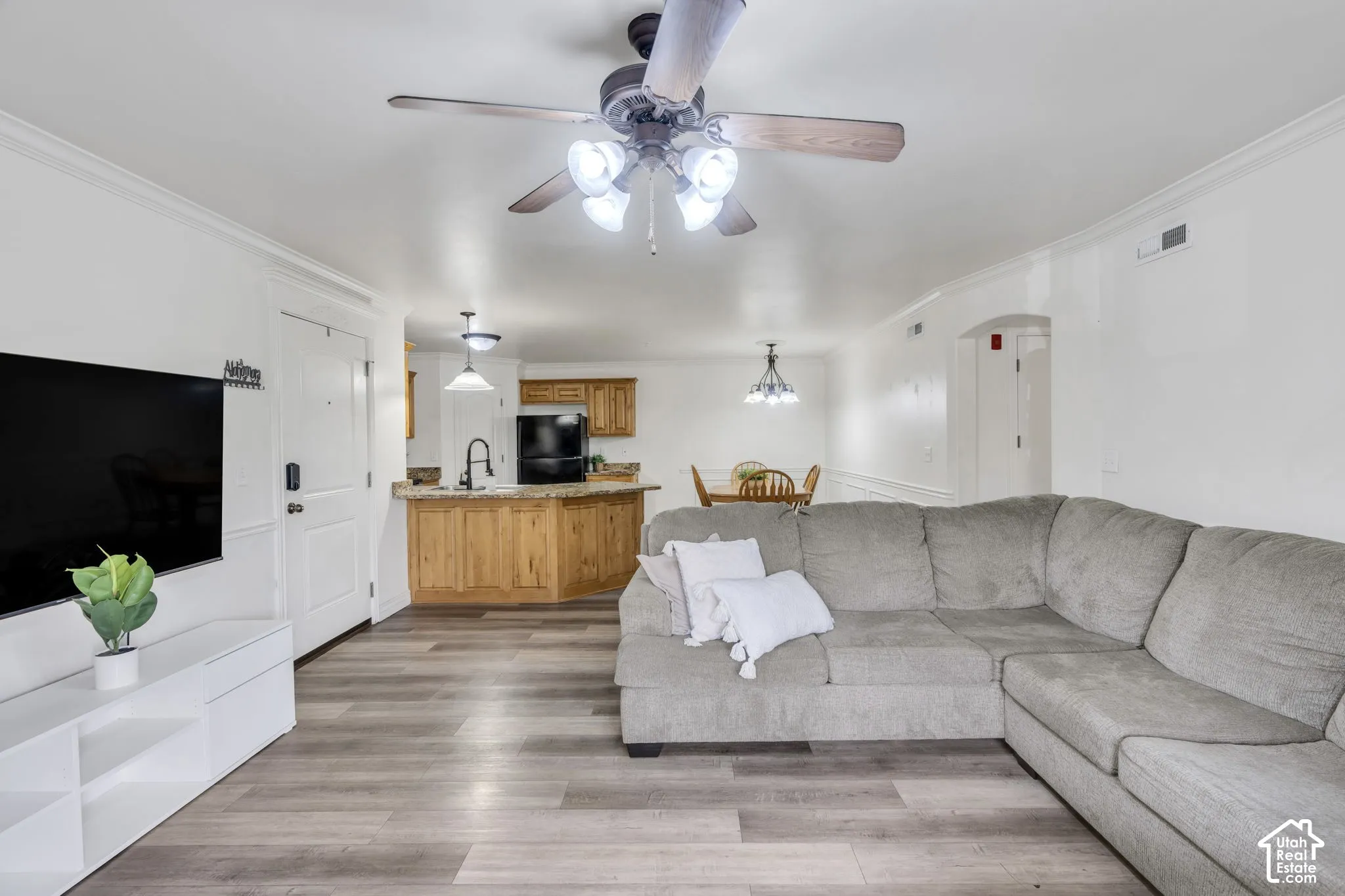 Open-concept interior featuring LVP flooring, a kitchen with wood cabinetry and granite countertops
