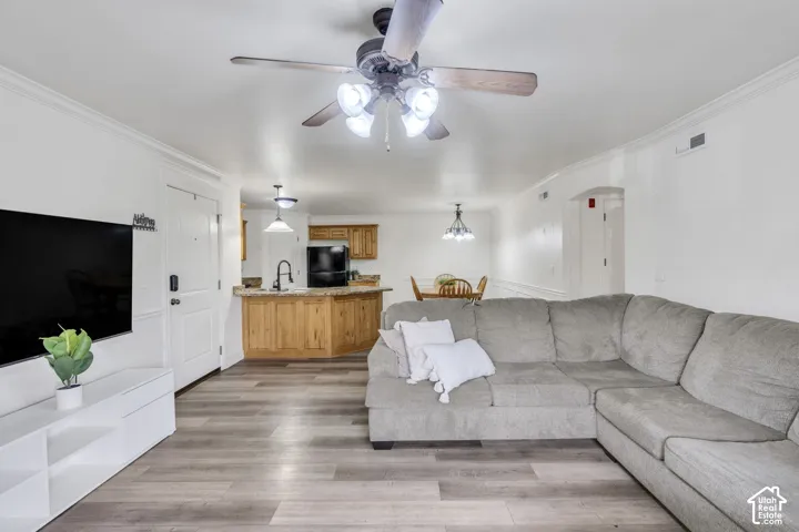 Open-concept interior featuring LVP flooring, a kitchen with wood cabinetry and granite countertops