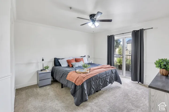 Bedroom featuring an ensuite bathroom,  a central ceiling fan with integrated lighting, and a sliding glass door providing access to a private balcony