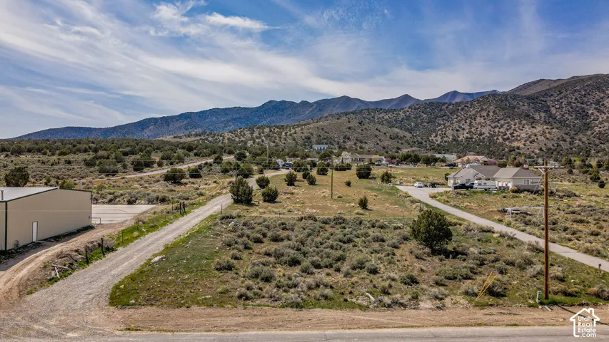 Vacant land parcel featuring native desert vegetation and mountain backdrop