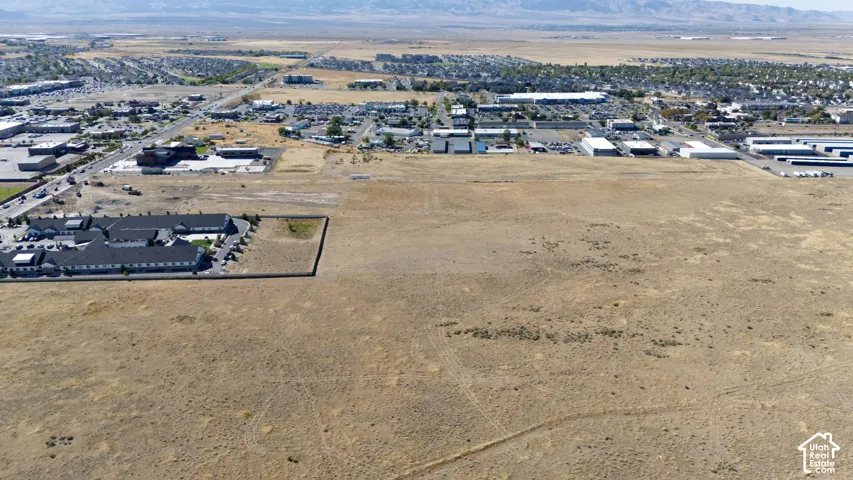 Expansive undeveloped land with surrounding commercial and residential areas