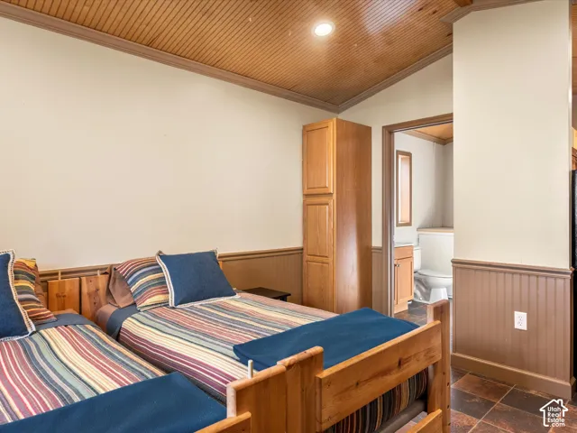 Room featuring beadboard wainscoting, tongue-and-groove wood-finish ceiling, recessed lighting, tile flooring, and built-in floor-to-ceiling cabinetry