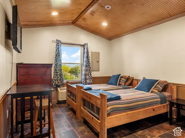 Vaulted tongue-and-groove wood ceiling, recessed lighting, and slate-finish tile flooring