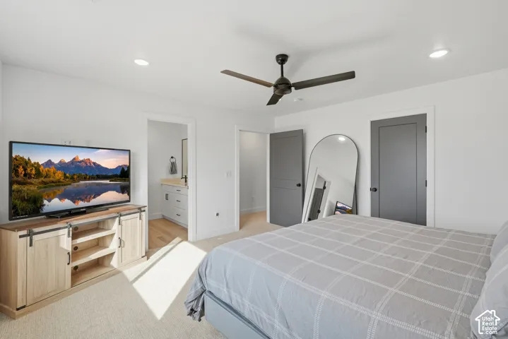 Neutral-toned room featuring high-contrast gray doors, recessed lighting, a modern ceiling fan, and wall-to-wall carpeting