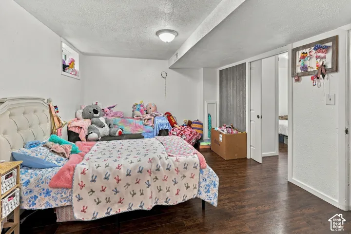 Interior space featuring wood-finish flooring, white walls, flush-mount ceiling lighting, and a recessed window