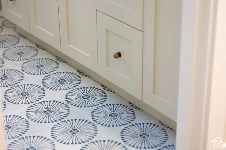 Patterned tile flooring with a light blue and white motif