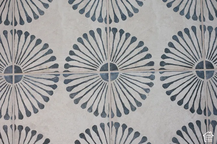 Decorative tile flooring featuring a repeating sunburst pattern