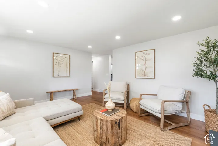 Hardwood-style flooring throughout, recessed ceiling lighting, and light-toned wall finishes