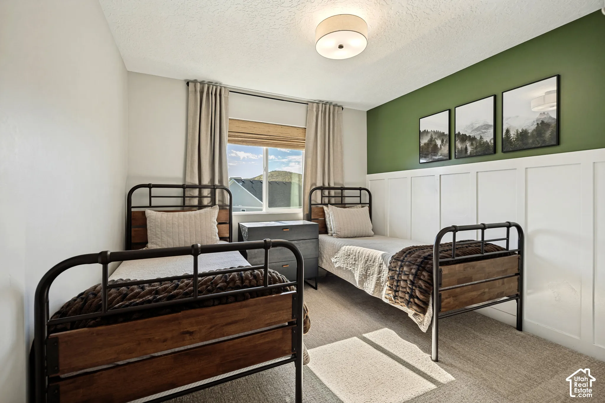 Room featuring board and batten wainscoting, an accent wall, wall-to-wall carpeting, and a flush-mount ceiling light fixture