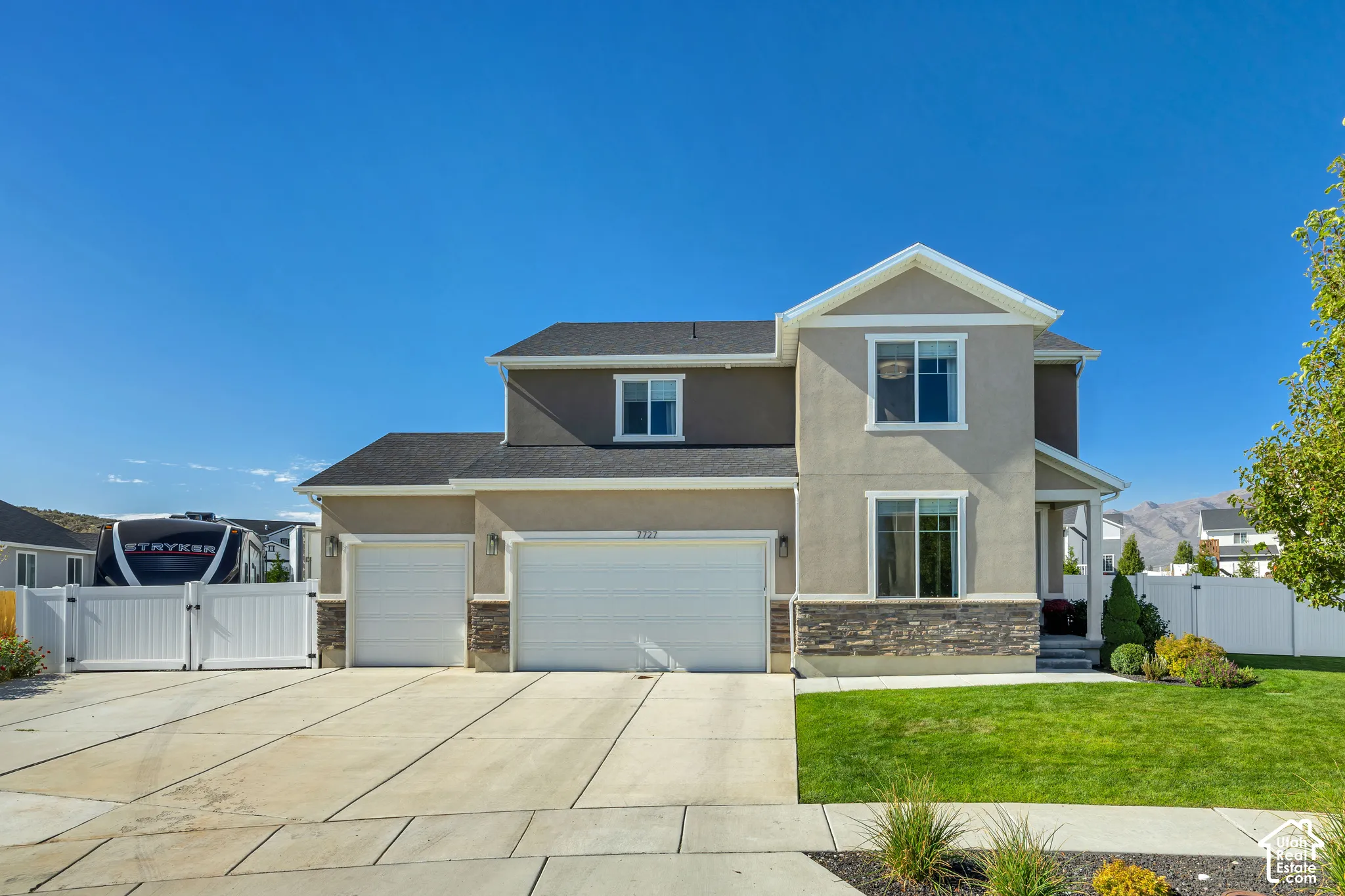 Two-story exterior featuring a stone and stucco fa