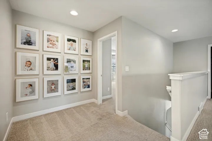Neutral wall palette, neutral-toned wall-to-wall carpeting, and recessed ceiling lighting
