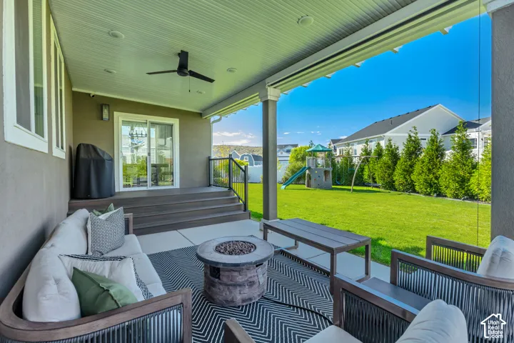 Covered patio featuring a beadboard ceiling with recessed lighting and a ceiling fan, a tiered composite deck, and a concrete patio slab