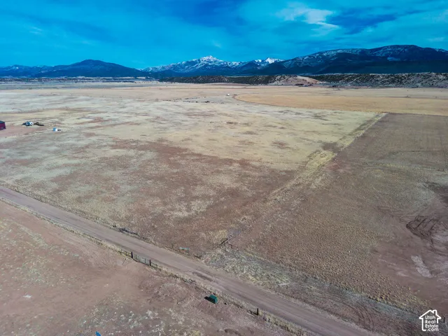 Expansive acreage featuring flat, open terrain and prominent mountain range backdrop