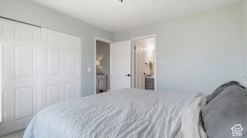 Neutral wall color with crisp white trim, sliding paneled closet doors, and solid-core interior doors with matte black hardware