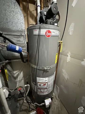 Professional-grade Rheem water heater featuring a high-capacity tank, integrated gas control valve, and metal reinforced strap mounting