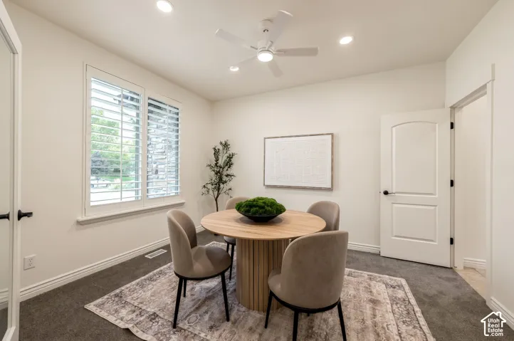 Interior room featuring high-profile plantation shutters, neutral wall color, recessed lighting, a modern ceiling fan, and arched-panel interior doors
