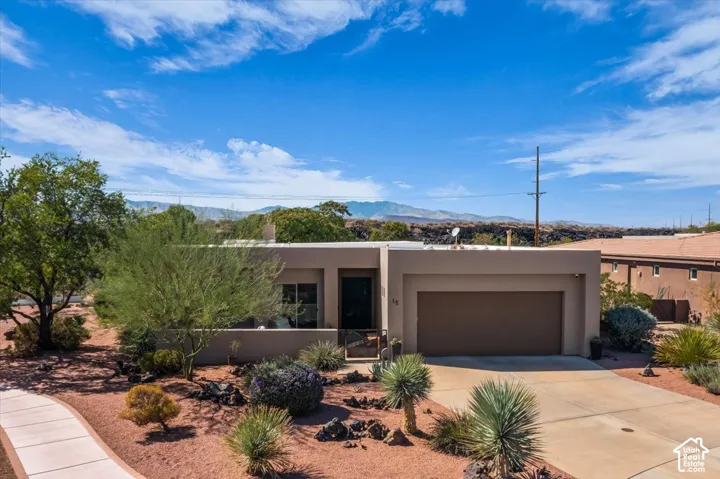 Single-story stucco exterior with an integrated garage