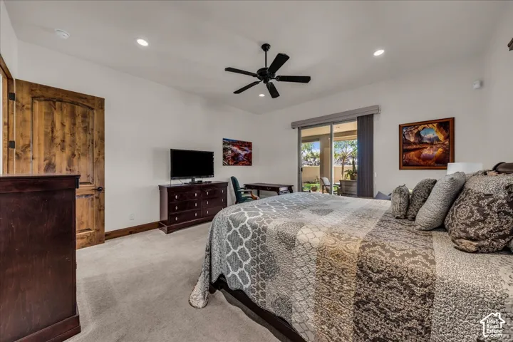 Wood-finish interior door, recessed lighting, ceiling fan, and sliding glass door to exterior