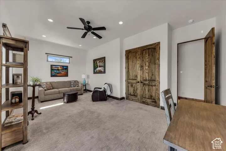 Recessed ceiling lights, wood-finish doors, ceiling fan, and a transom window