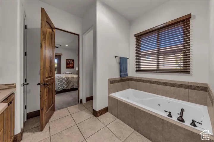 Soaking tub with tile surround and decorative mosaic accent