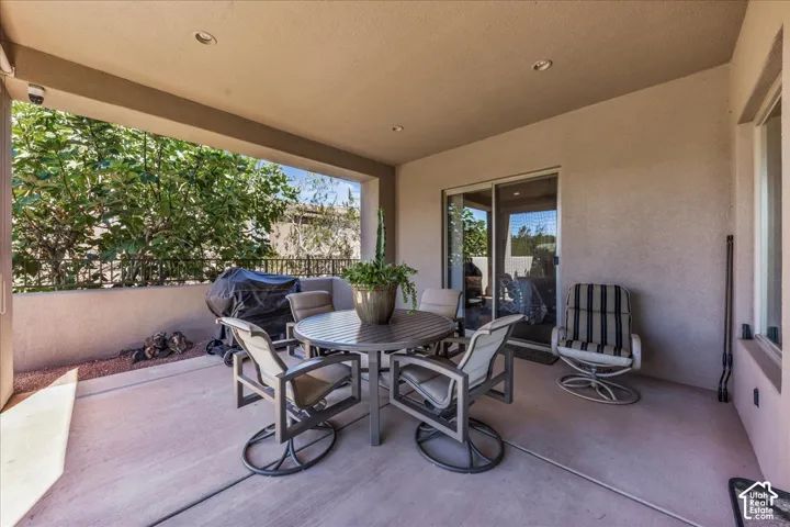 Covered patio featuring recessed lighting, smooth stucco exterior, and concrete flooring