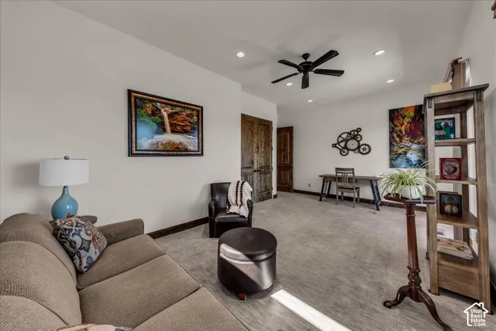 Recessed lighting, ceiling fan, and textured carpeting