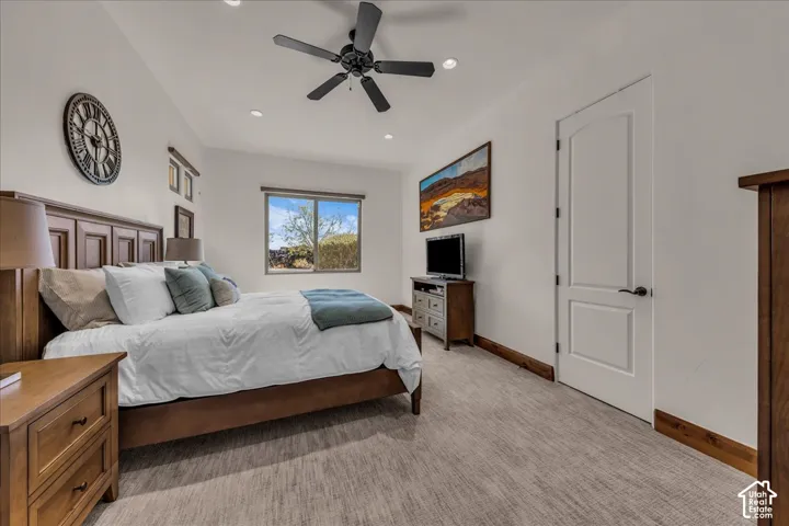Recessed lighting, ceiling fan, wood-finish flooring, white paneled door, and a single window
