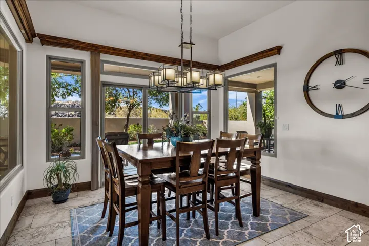 Dining area with tile flooring, wood-finish trim, and large windows