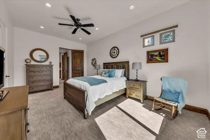 Recessed lighting, ceiling fan, two transom windows, and wood-finish doors