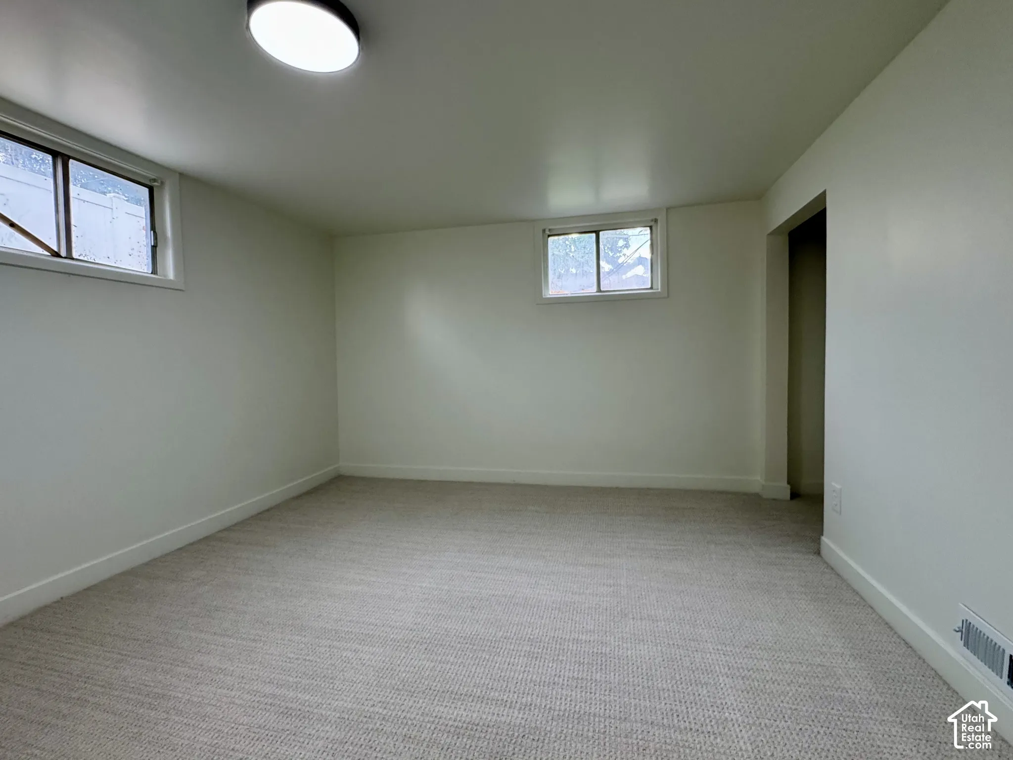 Basement level bedroom 1 with new fresh carpet.